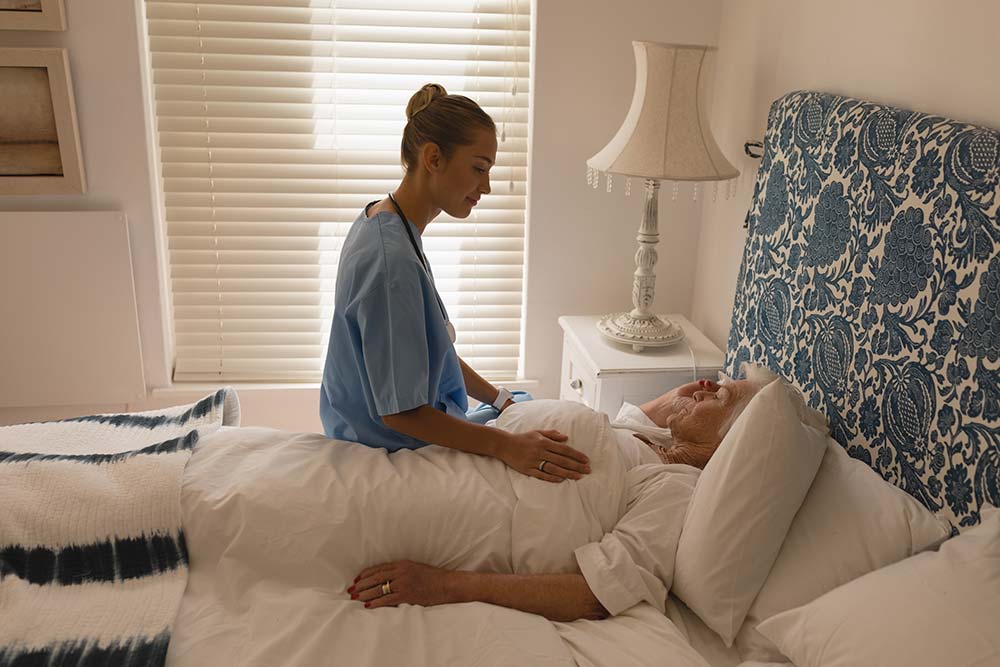 Nurse working with a hospice care patient in their home.